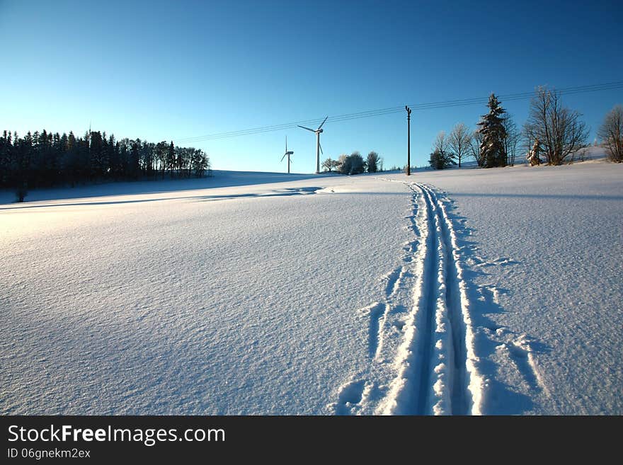 Electrical energy is in a winter landscape, track from skis in the snow