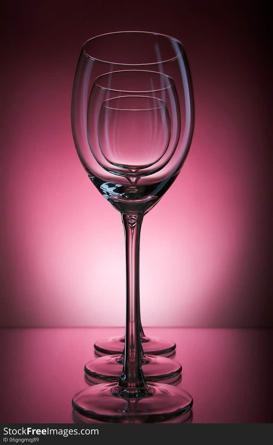 Three wine glass on a burgundy background