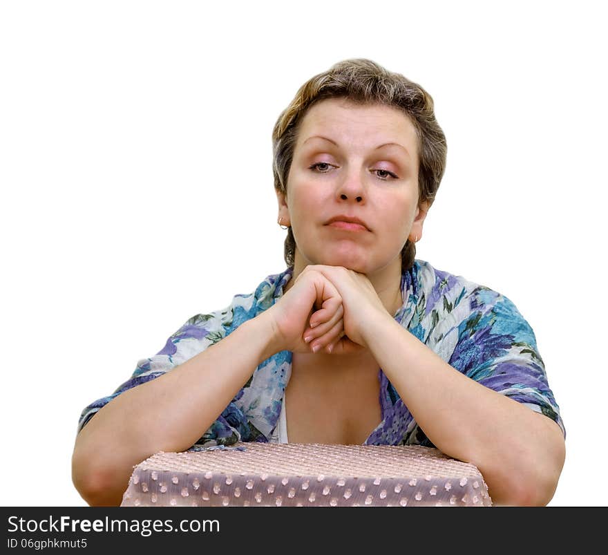 Isolated Portrait of a woman. Elbows are put on a chair. Hands support the head.