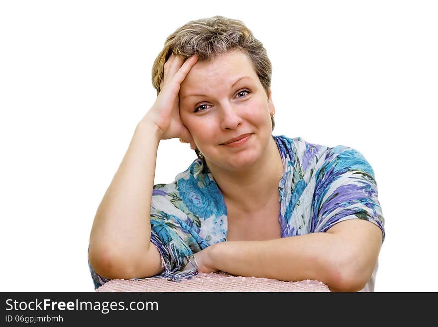 Isolated Portrait of a woman. Elbows are put on a chair. Hands support the head.