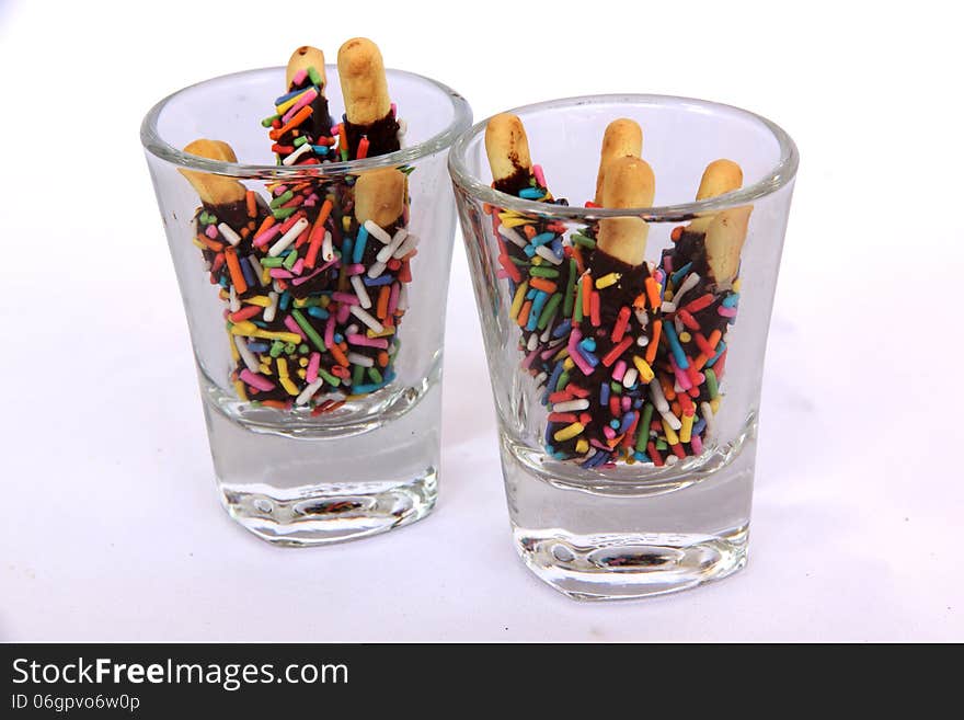 Snack chocolate in glass cup sprinkled with sugar color