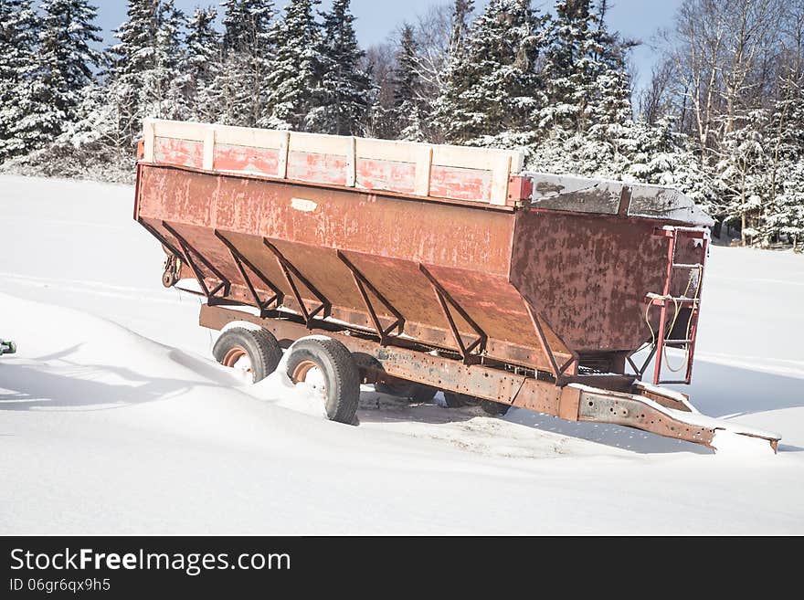 Rusted covered steel wagon in a field