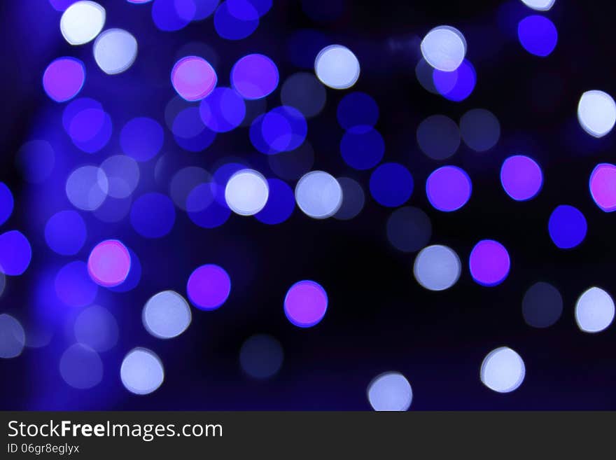 White, blue and purplre bokeh on dark background