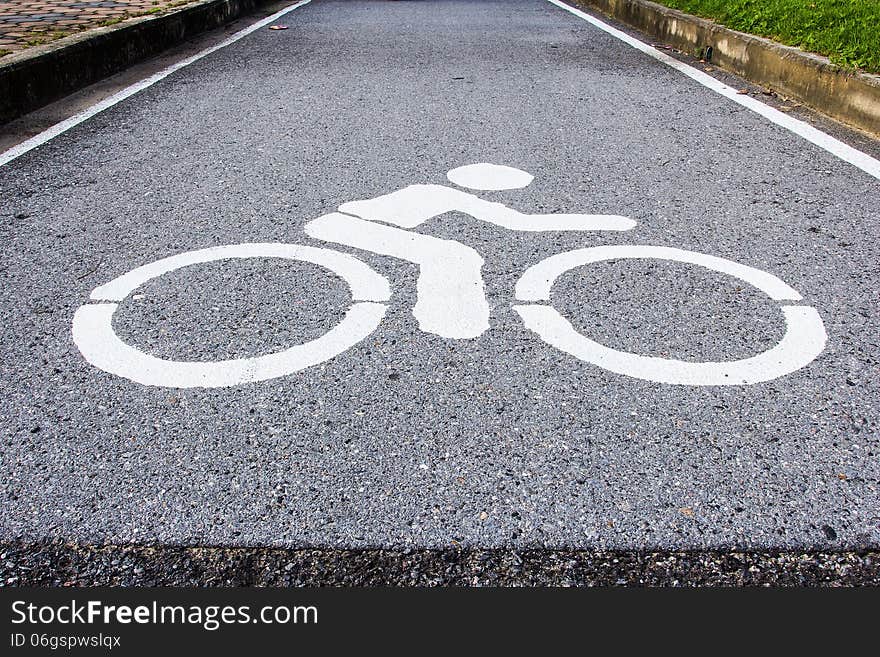 Asphalt road with cycle track and bike sign. Asphalt road with cycle track and bike sign.