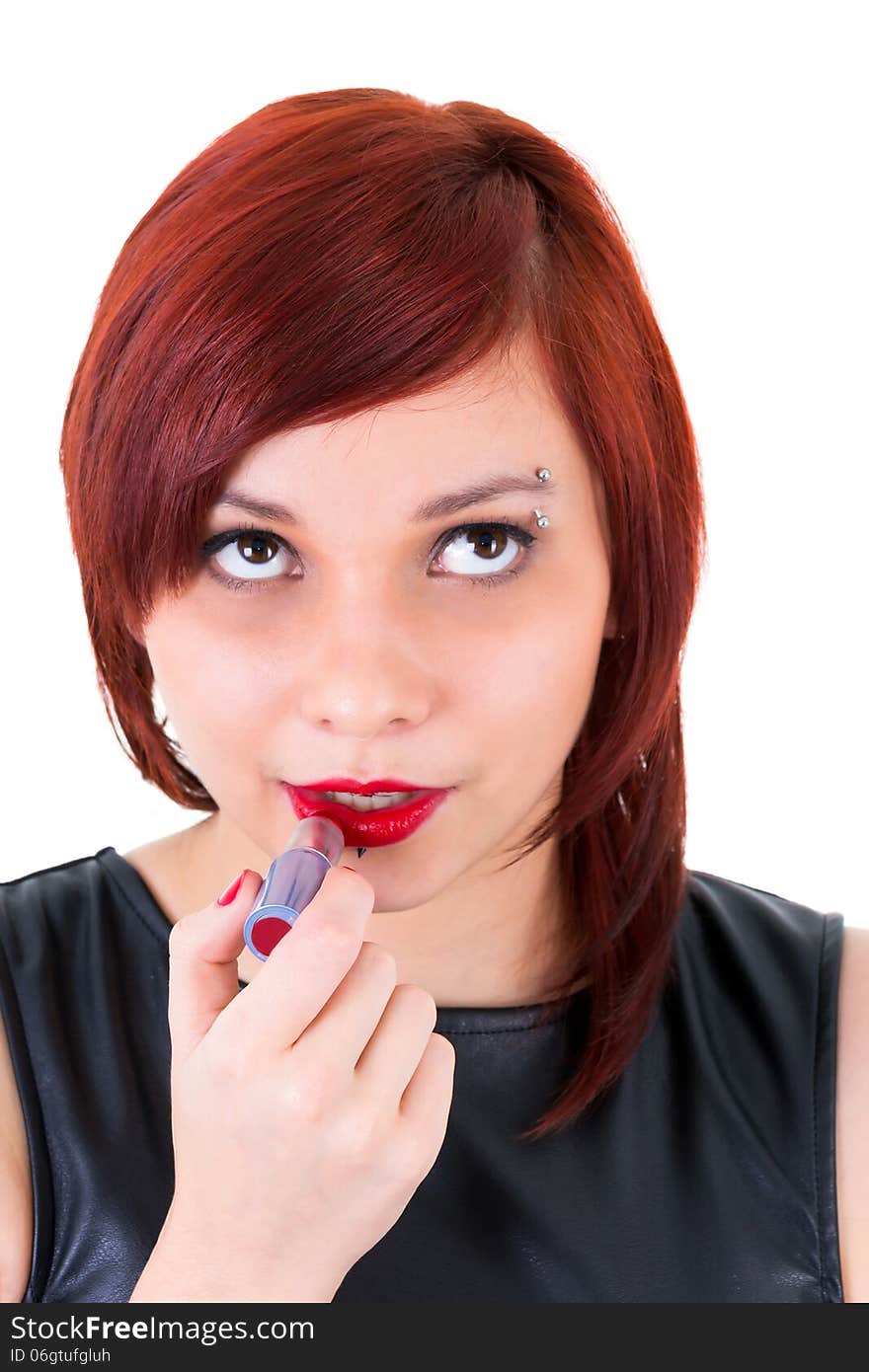 Teenage girl applying lipstick