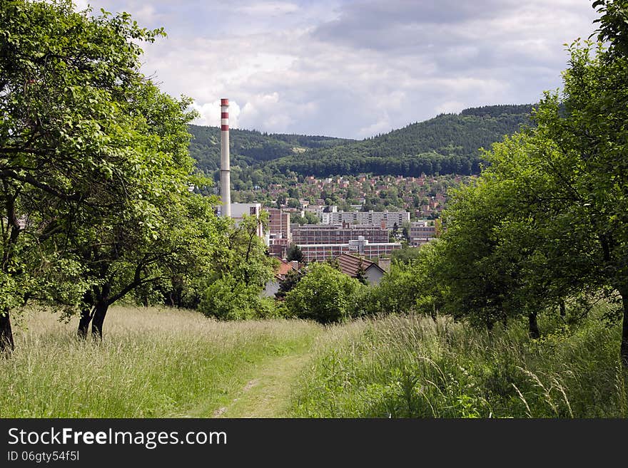 View of industrial city in a valley surrounded by green hills with forest, Zlin, Czech Republic. View of industrial city in a valley surrounded by green hills with forest, Zlin, Czech Republic.