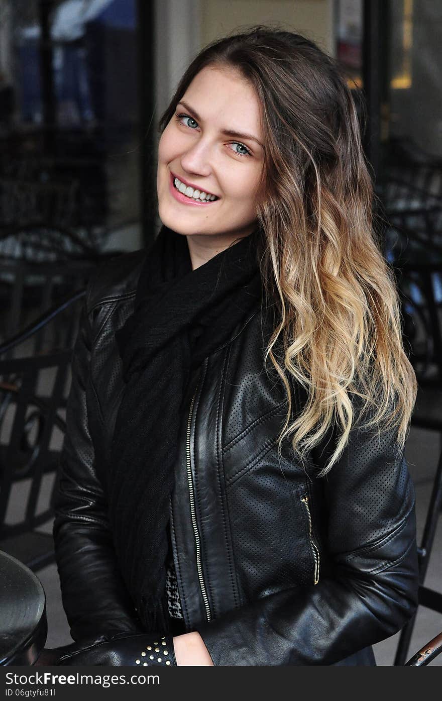 Sitting woman wearing fashionable black jacket. Sitting woman wearing fashionable black jacket.