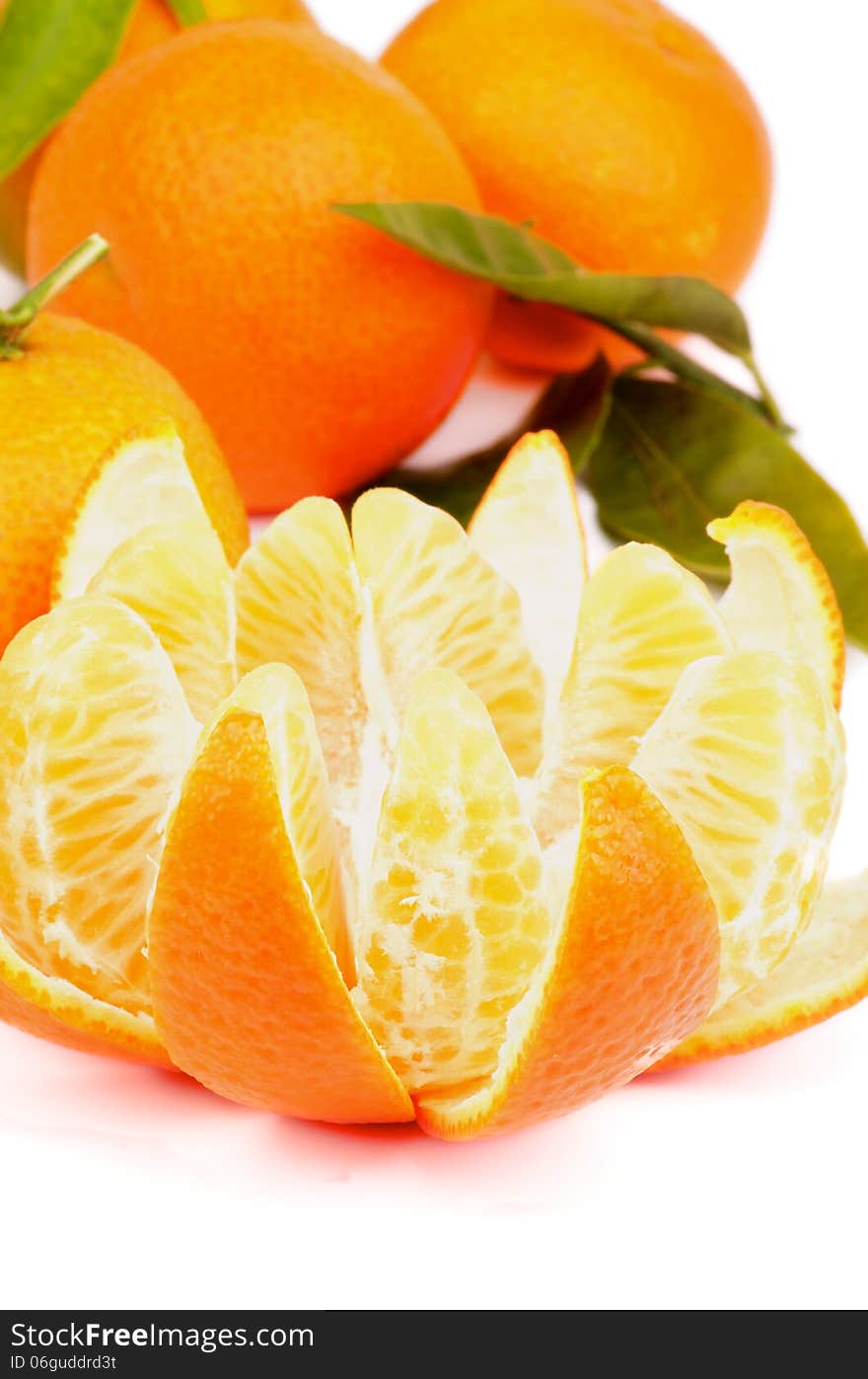 Fresh Ripe Tangerine with Segments and Citrus Peel and Some Full Body with Leafs closeup on white background