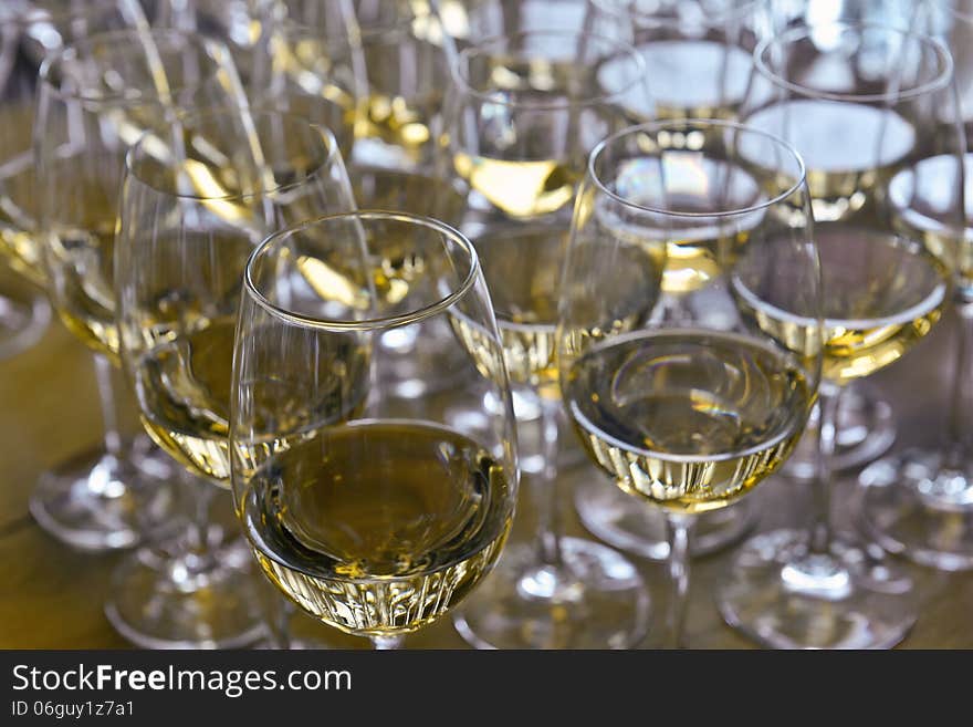 Glasses with wine on table - party background