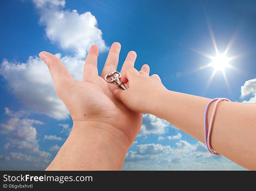 Father give son key on sunny sky background