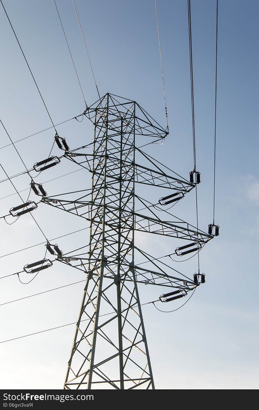 Electricity Poles against a cloudy sky.