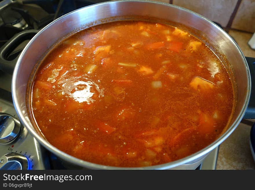 A picture of homemade soup cooking on the stove.