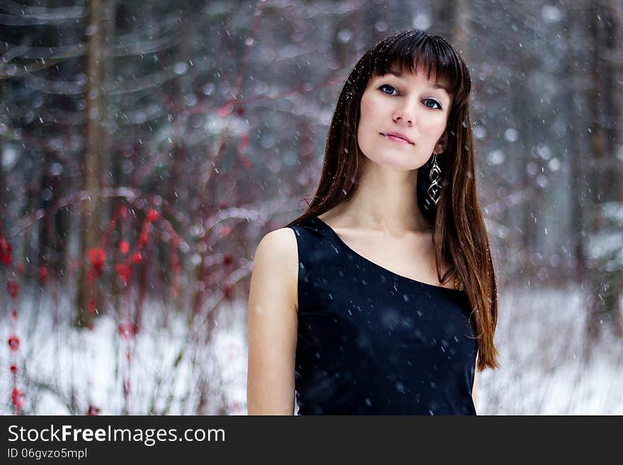 Portrait of beautiful woman in snow winter forest