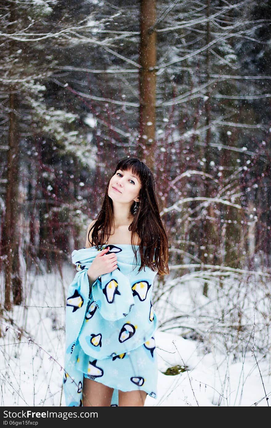 Beautiful Woman Under Warm Cute Wrap In Cold Snow Forest