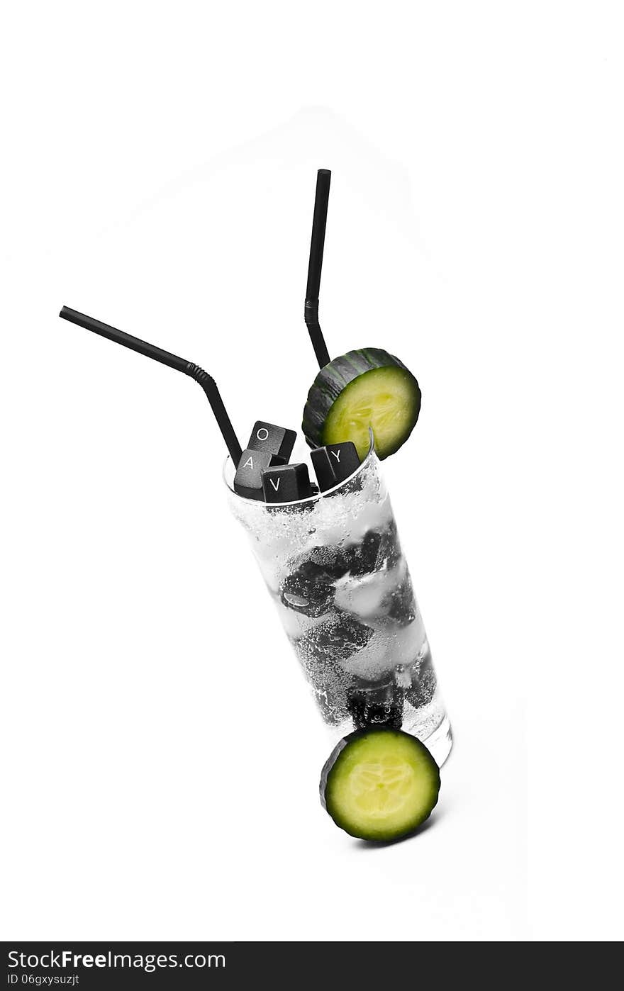 Keyboard and cucumber cocktail on ice rocks against white background