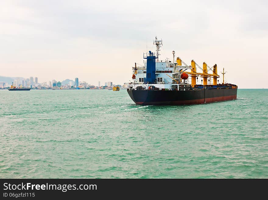 Cargo ship on the Island seascape background