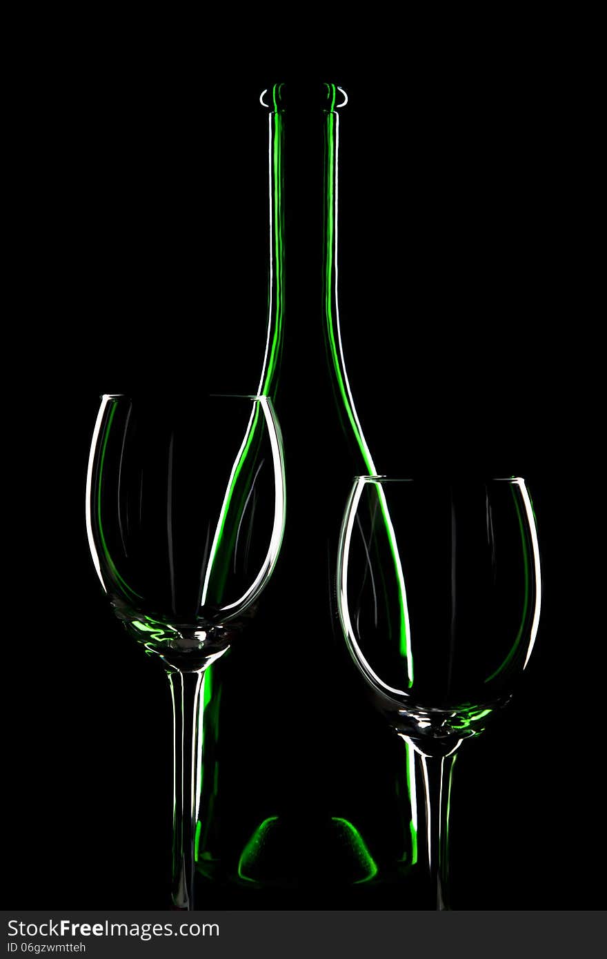 Two empty wine glass and a bottle