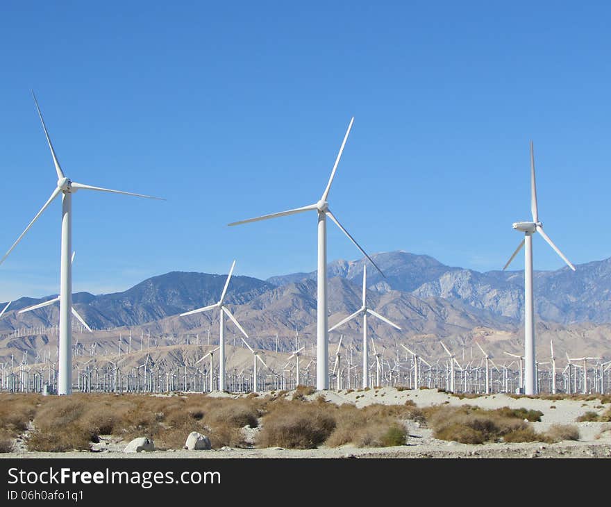 Desert Windmills With Mountains