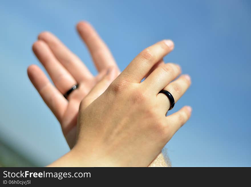 Hands with black wedding rings. Hands with black wedding rings