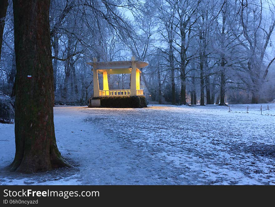 Warm lights of music chapel in a snowcoverd park on a cold winter moring