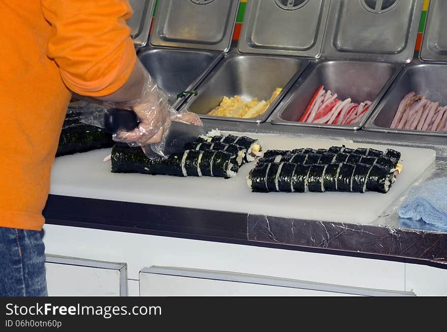 Kim Bap, better known in the USA as California Rolls, being freshly prepared at market. Kim Bap, better known in the USA as California Rolls, being freshly prepared at market.