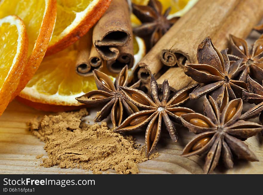 Cinnamon sticks and powder, anise stars and slices of dried orange. Cinnamon sticks and powder, anise stars and slices of dried orange