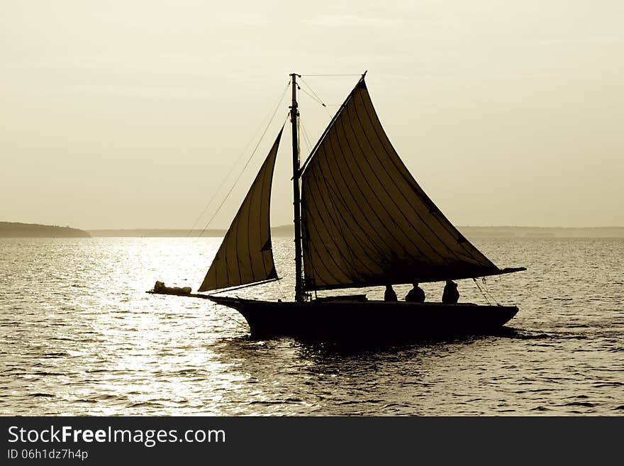 A sailboat on the lake with sun setting. A sailboat on the lake with sun setting