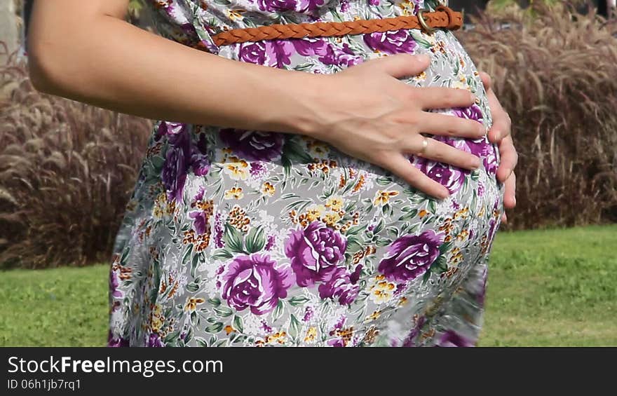 Pregnant woman stroking her belly