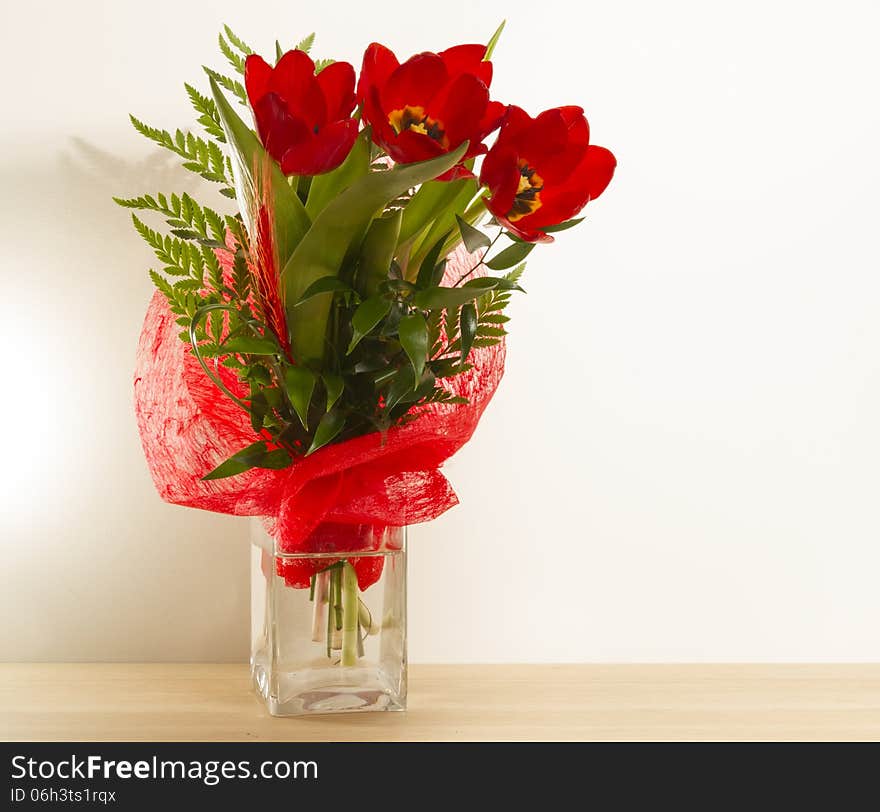 Bouquet red tulips green leaves wallpaper