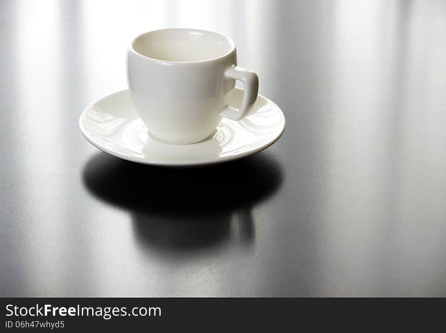 Coffee white cup and plate on black table with nice reflection. Coffee white cup and plate on black table with nice reflection