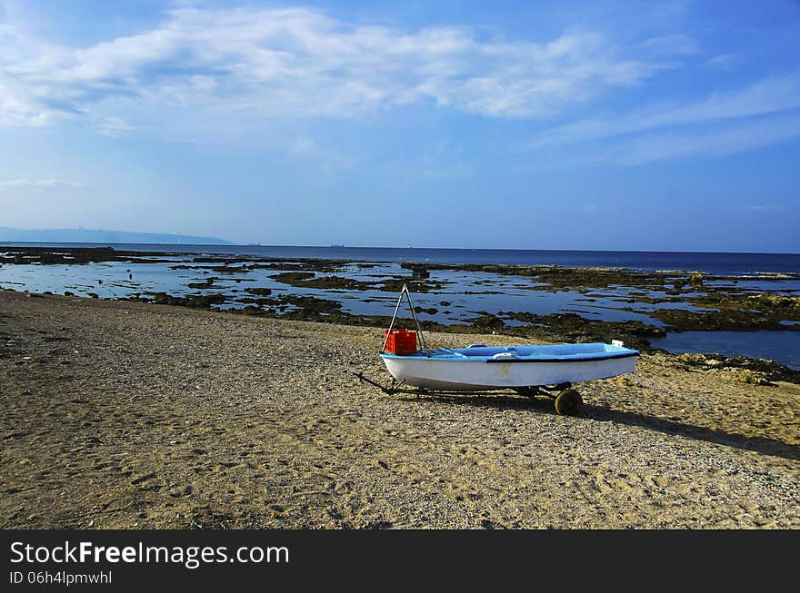 Fishing boat standing on the sand of a beach