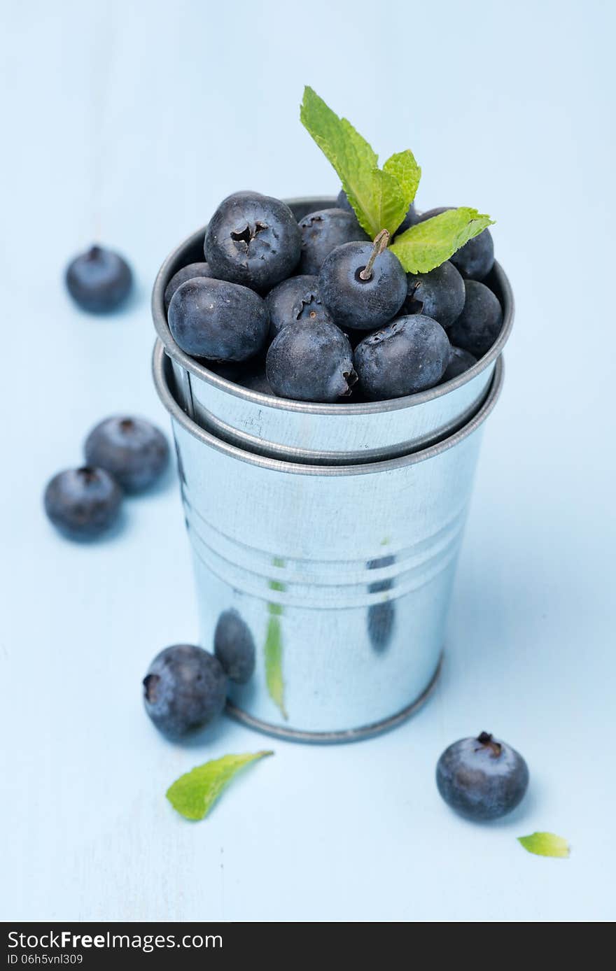 Metal bucket with fresh blueberries