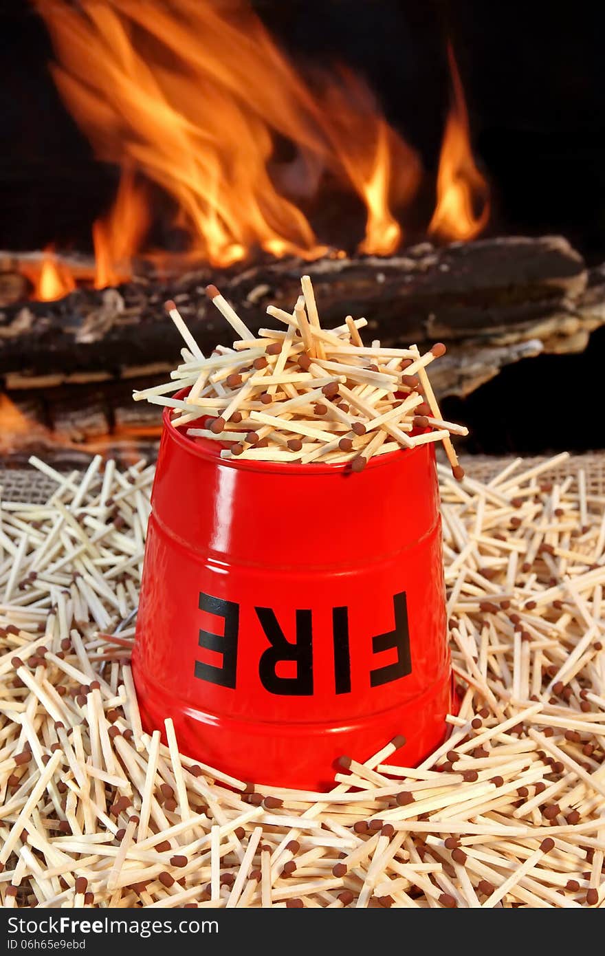 Inverted fire-bucket on a pile of matches against the flames. Inverted fire-bucket on a pile of matches against the flames