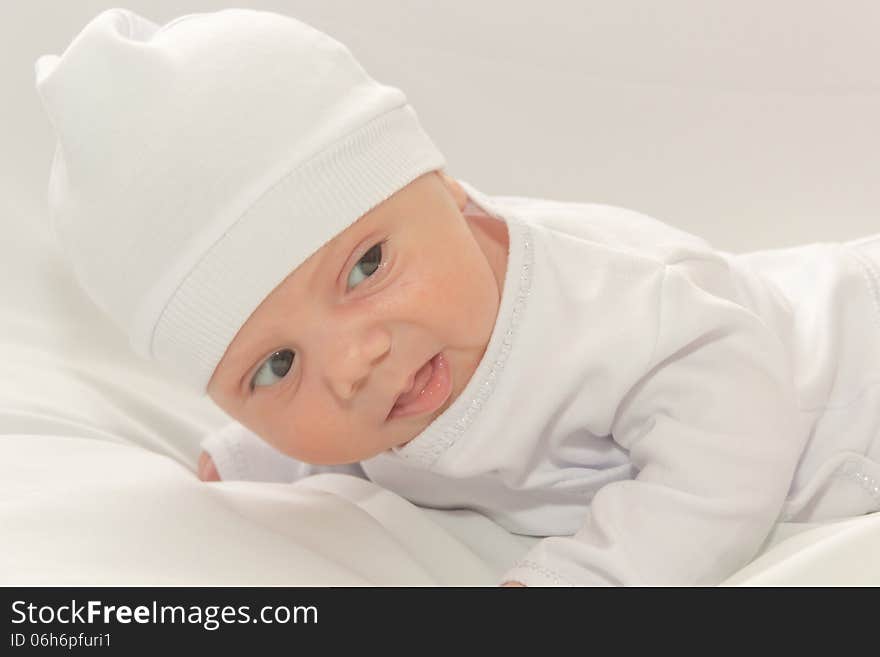 Babe in white a cap lies on white background. Babe in white a cap lies on white background