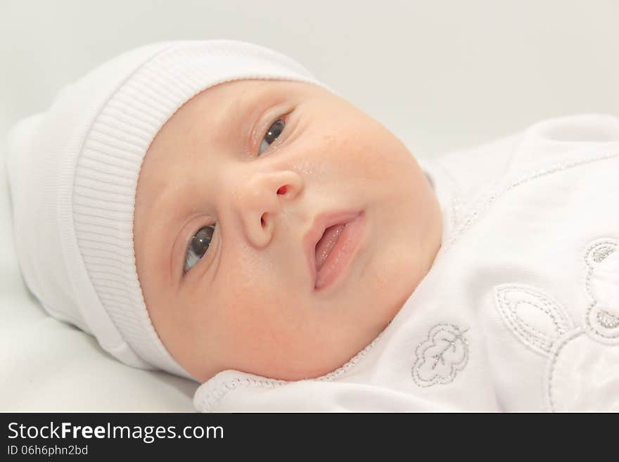 Babe in white a cap lies on white background. Babe in white a cap lies on white background