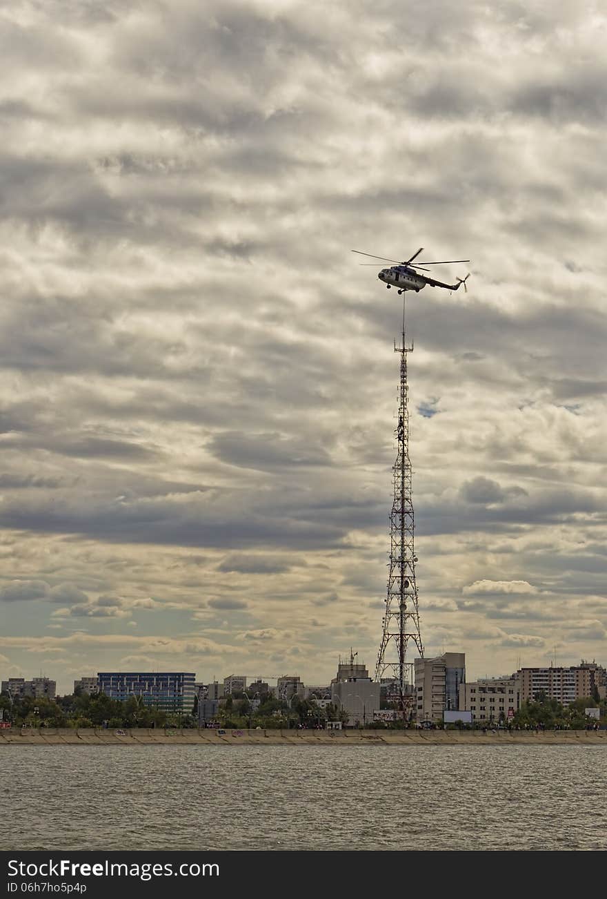 Helicopter Flight Demonstration at AeroNautic Show 2013 - Morii Lake, Bucharest. The helicopter just rescue 3 people from the lake and then I caught the moment when passing around antenna. Helicopter Flight Demonstration at AeroNautic Show 2013 - Morii Lake, Bucharest. The helicopter just rescue 3 people from the lake and then I caught the moment when passing around antenna.