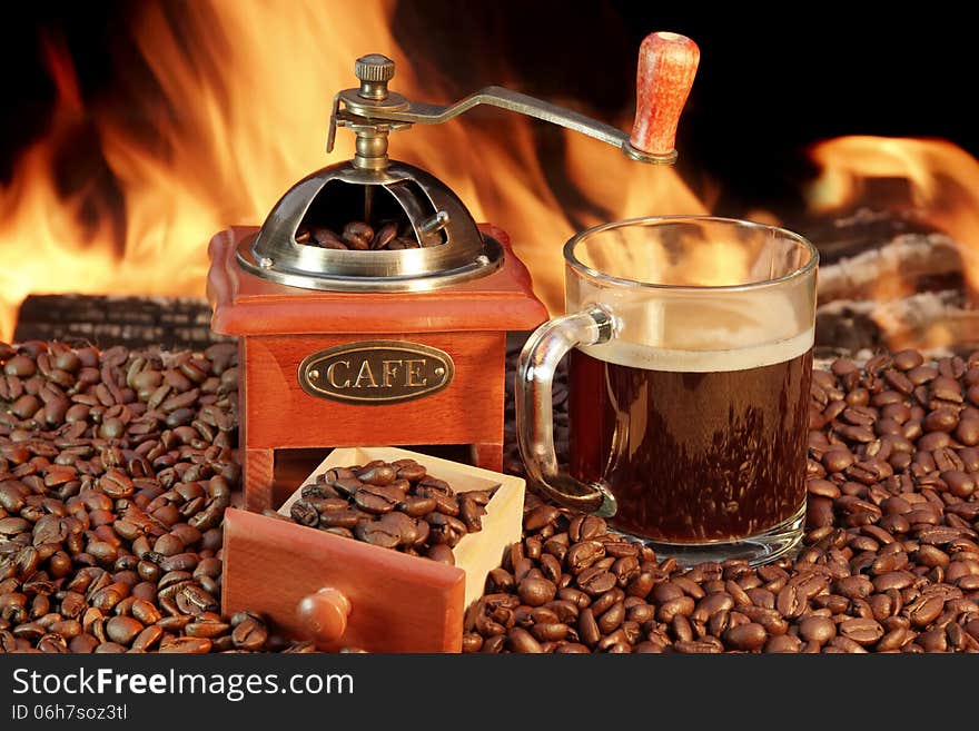 Coffee Mug and Old Coffee Grinder at the fireplace. Coffee Mug and Old Coffee Grinder at the fireplace