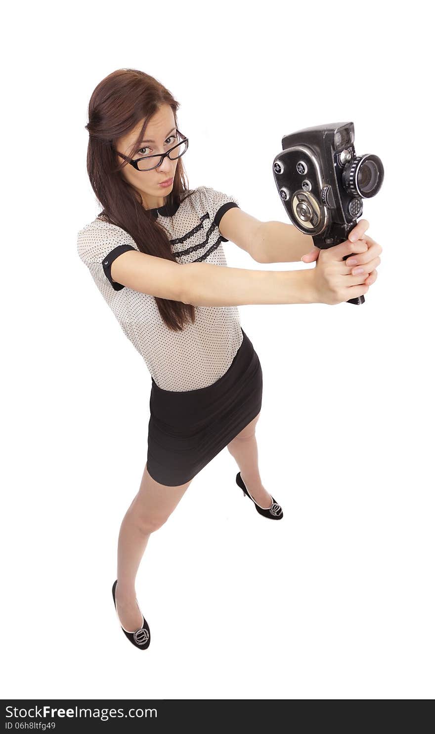 Girl with old movie camera on white background