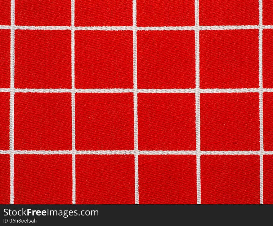 Red and white gingham tablecloth pattern, close-up.