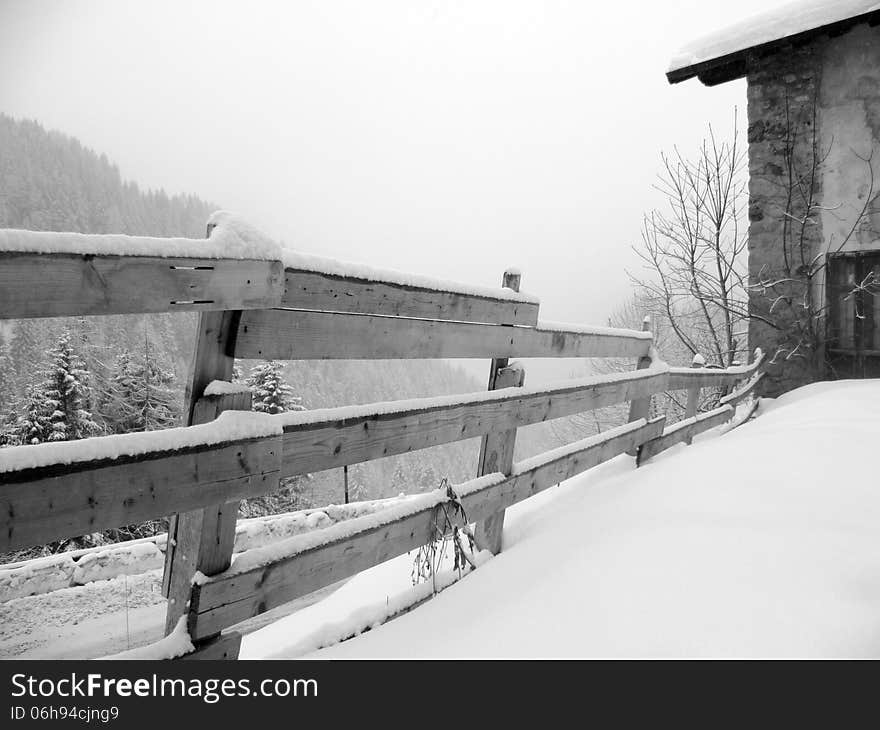 Wooden fence in winter, black and white photo. Wooden fence in winter, black and white photo