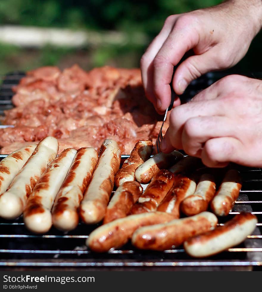 Meat and sausages on the grill background. Meat and sausages on the grill background