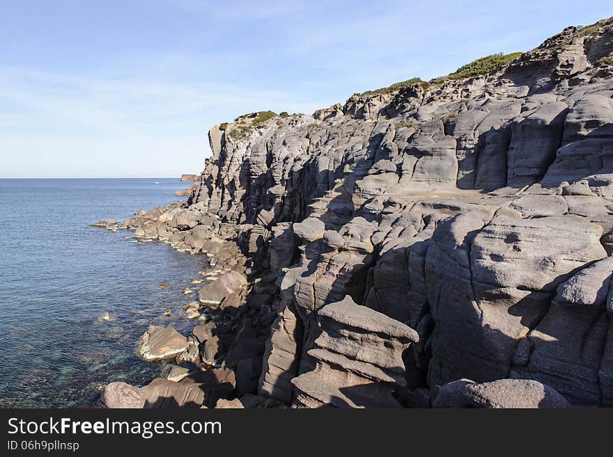 Along the west coast of Sardinia, the cliffs are silhouetted against the sea. Storm surges give special forms. Along the west coast of Sardinia, the cliffs are silhouetted against the sea. Storm surges give special forms.