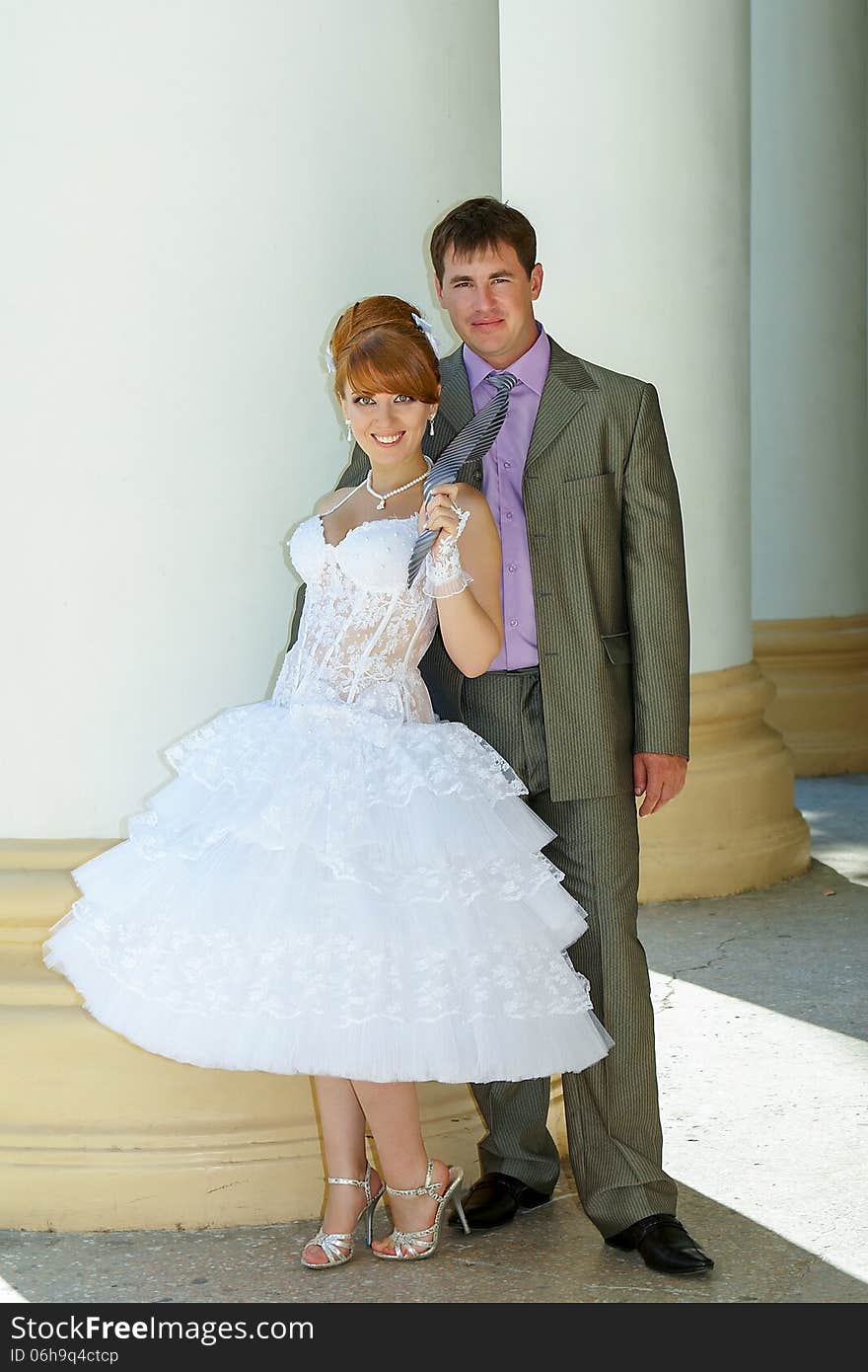 Beautiful charming bride short dress and happy groom. Beautiful charming bride short dress and happy groom