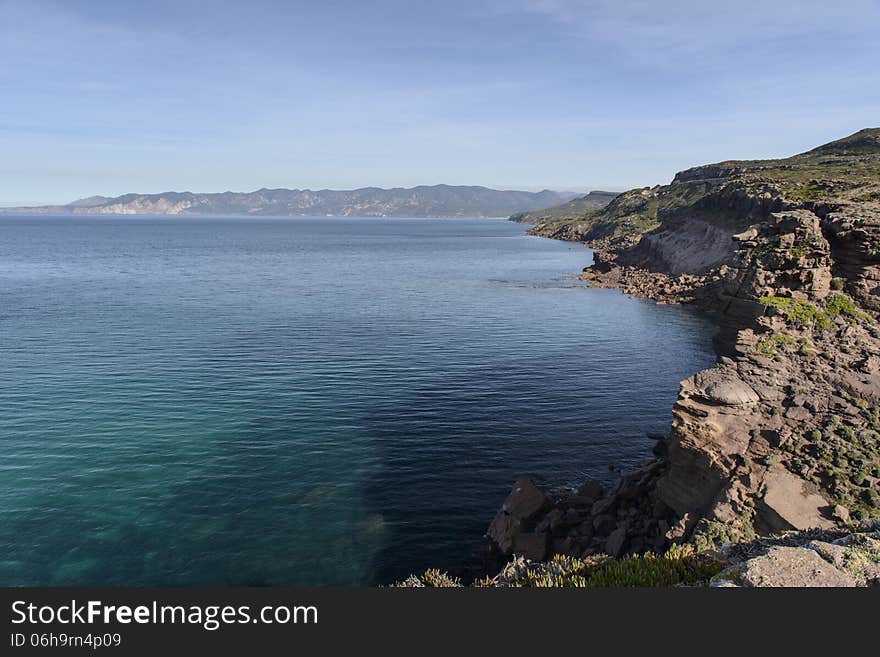 Along the west coast of Sardinia, the cliffs are silhouetted against the sea. Storm surges give special forms. Along the west coast of Sardinia, the cliffs are silhouetted against the sea. Storm surges give special forms.