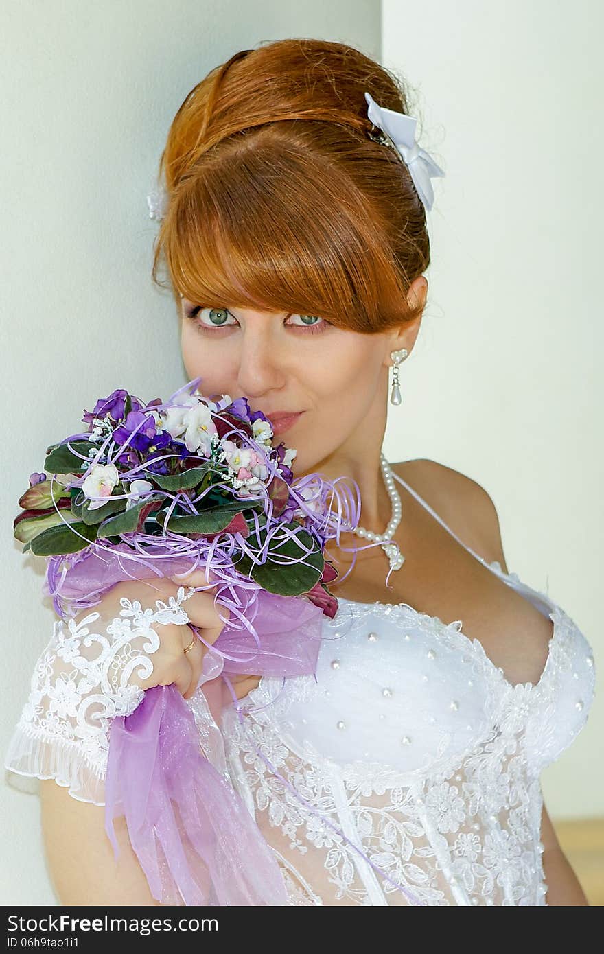 Portrait of a beautiful redhead bride with big eyes on a sunny day. Portrait of a beautiful redhead bride with big eyes on a sunny day