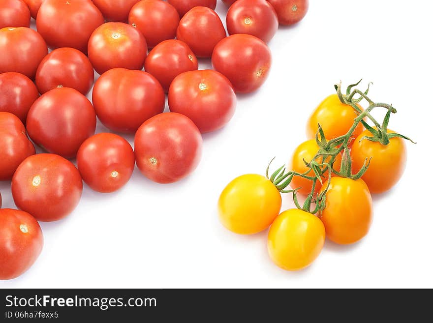 Yellow and red tomatoes on a white background