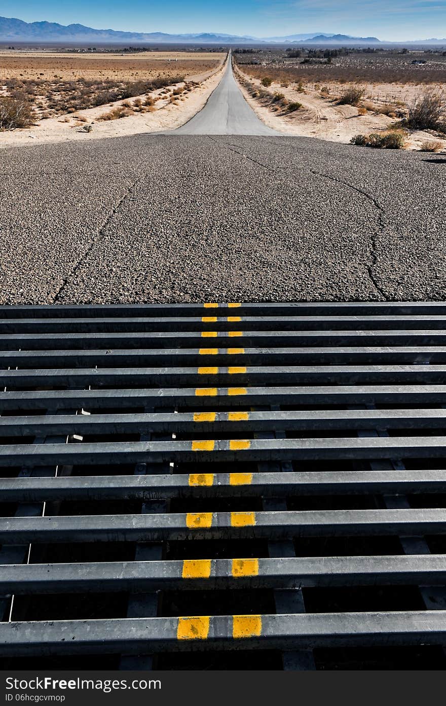 Cattle grate crossing in a road to mountains