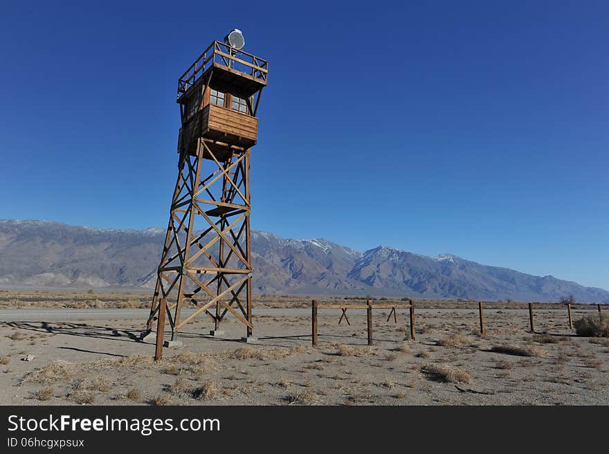 Wooden guard tower in desert by mountains