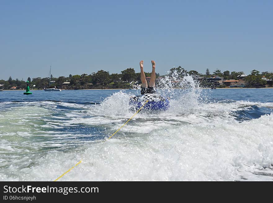 Male teen water skiing tubing in the swan river perth. Male teen water skiing tubing in the swan river perth