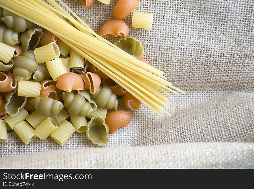 Uncooked pasta on natural fabric